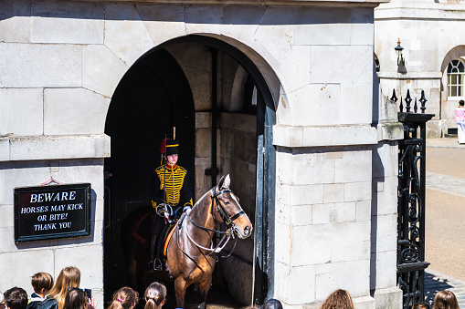 London, United Kingdom - June 22, 2018: Horse guard parade at Household cavalry museum of Whitehall street with warning beware sign, people in summer