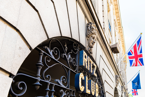 London, United Kingdom - June 22, 2018: Piccadilly circus street road with Ritz Carlton Ritz club hotel neon bulb light sign, Union Jack British flag