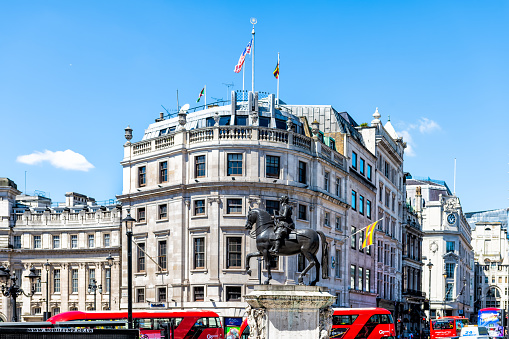 London, United Kingdom - June 22, 2018: Trafalgar square with equestrian statue of King Charles I and Uganda High Commission flag by embassy