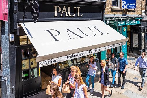 London, United Kingdom - June 22, 2018: High angle view on Paul French bakery, sandwich shop store cafe restaurant sign with people on Fleet street