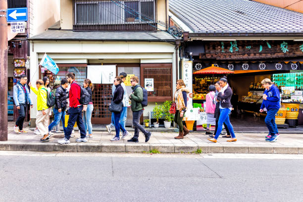 Guided tour group with guide in old town of Kyoto in Arashiyama city, Ukyo ward stock photo