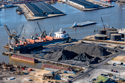 A large ship loading coal for transport along the banks of the Mobile River in Mobile Alabama shot from an altitude of about 600 feet.