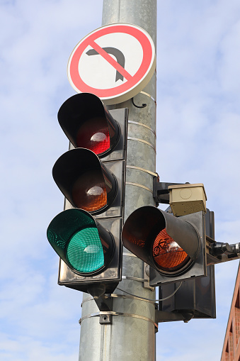 Traffic lights at the road crossing on a pole
