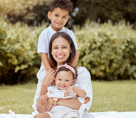 Happy, family and picnic of a mom, baby and boy in a park in nature having fun in summer. Portrait of woman and young kids from Mexico with happiness, love and care outdoor with youth care together