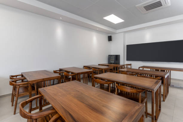 istock New empty classroom with long tables and chairs 1447159653