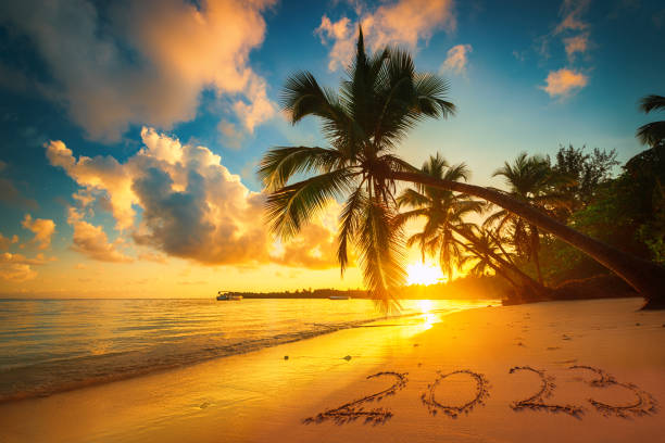 Happy New Year 2023 text on island beach sand. Sea sunrise. Punta Cana, Dominican Republic stock photo
