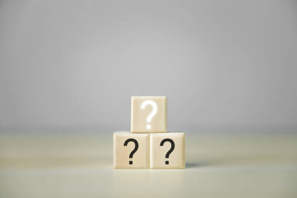 istock The wooden block shows white and black question marks. On a gray background. 1447161218