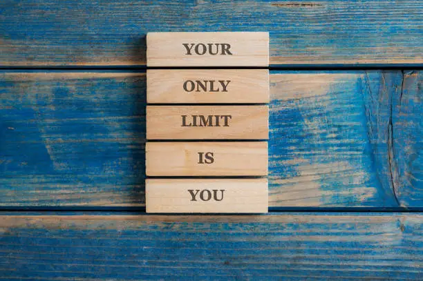 Photo of Your only limit is you sign written on a stack of five wooden pegs