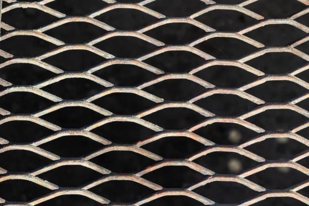 istock Background from a metal brilliant lattice on a black background 1447161594
