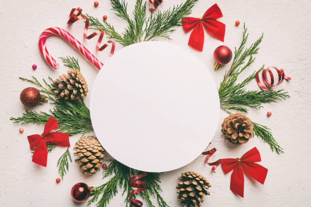 istock Flat lay Christmas composition. Round Paper blank, pine tree branches, christmas decorations on Colored background. Top view, copy space for text 1447163431
