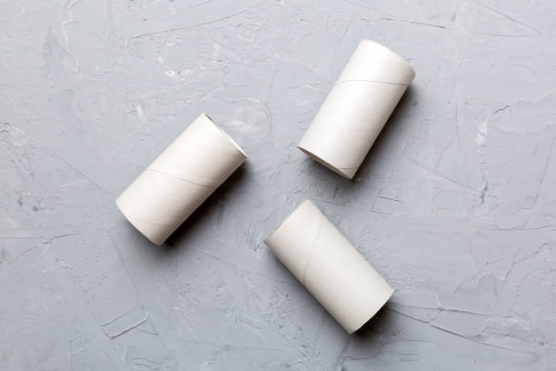 istock Flat lay composition with empty toilet paper rolls and space for text on color background. Recyclable paper tube with metal plug end made of kraft paper or cardboard 1447163445