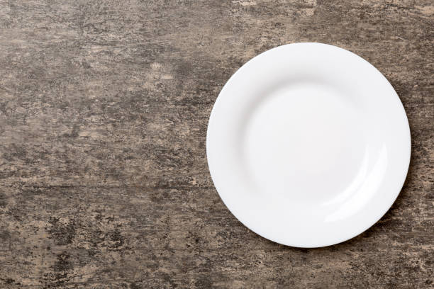 istock Top view of empty light plate on cement background. Empty space for your design 1447163447
