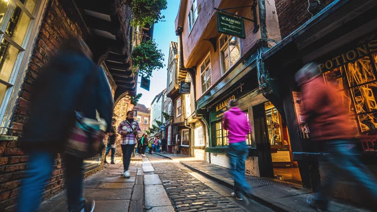 Time lapse of Crowd commuter and tourist walking and traveling around shopping street historic county town in The Shambles in York, North Yorkshire, England