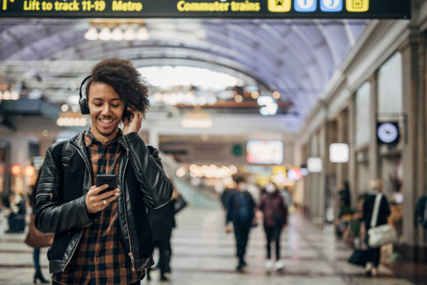istock Young hispanic man using phone in shopping mall 1447164462