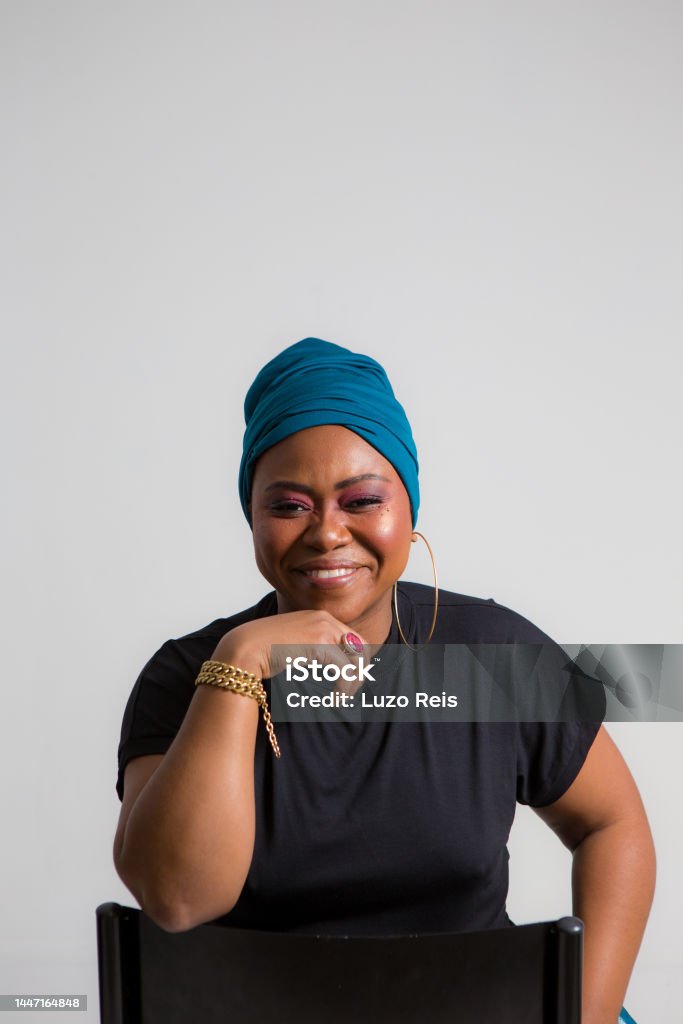 powerful black woman looking at the camera and smiling Black Color Stock Photo