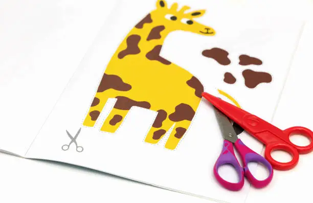 Child development concept. Peper cut out picture for kids with scissors.