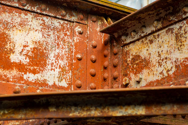 istock Old steel beams covered with rust. Heavy-duty bridge fasteners with rivets. 1447168079