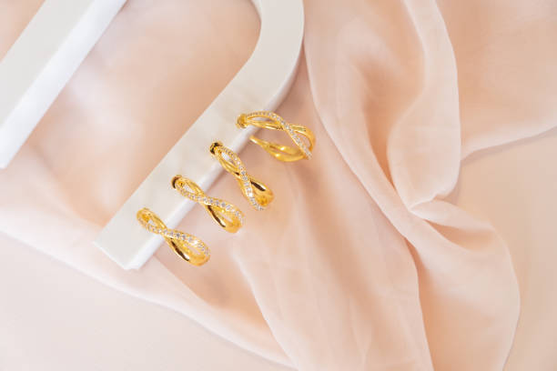 istock Hoop Earrings on white stand sitting on pink cloth 1447169951