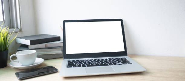 istock Laptop computer with white blank screen on wood desk. Workspace, workplace, desktop office concept. 1447172984