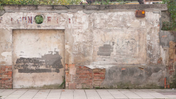 istock Ruined old wall in urban facade 1447173277