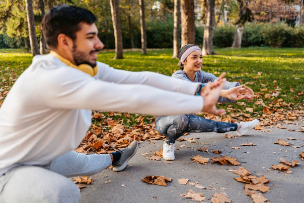 istock Young Couple Stretching Before Jogging In The Park 1447173466