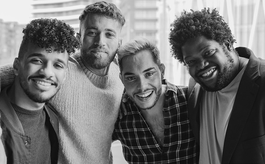 Young diverse men smiling on camera