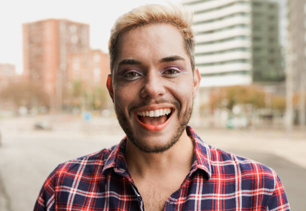 istock Young gay man with make up smiling on camera 1447176408