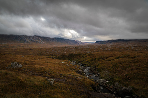 A dreich, autumnal HDR image of Cranstackie (L) and Foinaven (R) with Allt Na Gualine in the foreground, Sutherland, Scotland