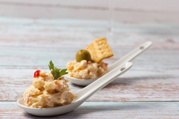 istock Russian salad appetizers in ceramic teaspoons on a wooden base 1447178235