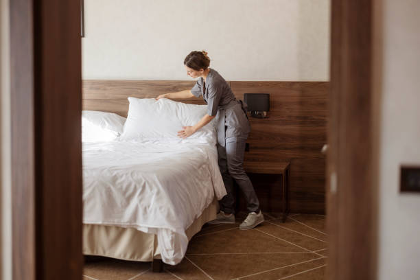 Staff maid making bed stock photo