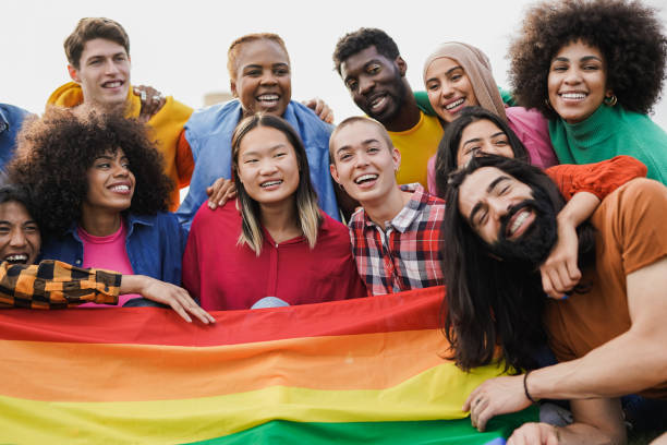 group of multiracial young people having fun together outdoor with lgbt rainbow flag - flag rainbow gay pride flag gay man imagens e fotografias de stock