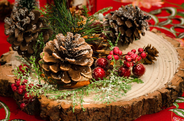 istock Christmas decoration with pine cones on a wooden board 1447180438