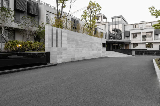 Empty asphalt road beside modern buildings