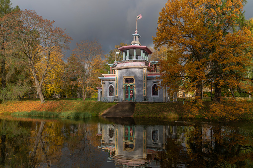 View of the Chinese gazebo on the bank of the Upper Ponds in the Catherine Park in Tsarskoye Selo on a sunny autumn day, Pushkin, St. Petersburg, Russia