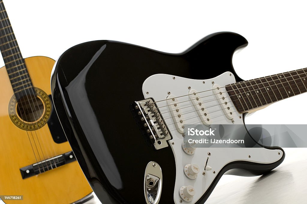 Electric guitar Electric guitar on white with a acoustic guitar in the background Acoustic Guitar Stock Photo