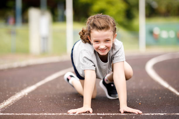 istock Little girl getting ready to start a running competition 1447185649