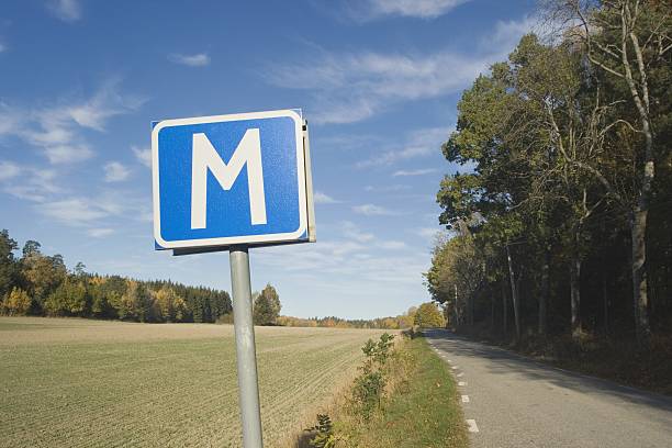 M-sign on narrow country road stock photo