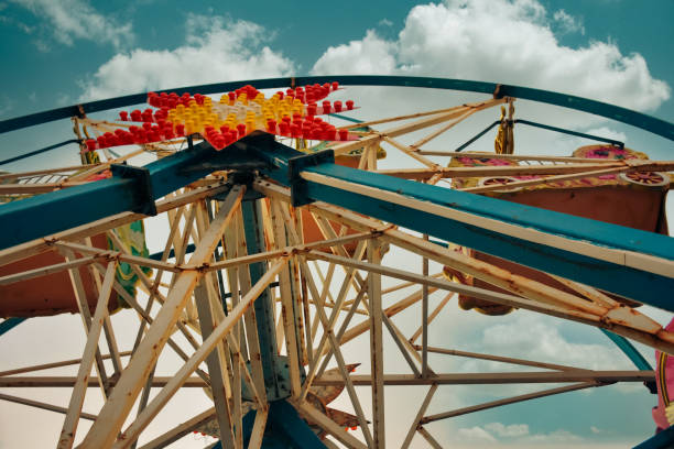 Close up of an Old abandoned rusty metal ferris wheel against blue sky. Detailed view of abandoned ferris wheel. Close up of an Old abandoned rusty metal ferris wheel against blue sky. Detailed view of abandoned Ferris wheel. abandoned roller coaster stock pictures, royalty-free photos & images