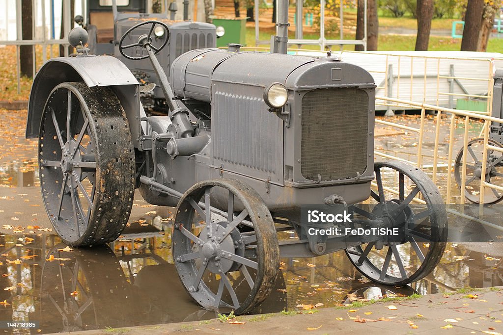 Old rarity tractor Old rarity tractor in autumn and its reflection Agricultural Machinery Stock Photo