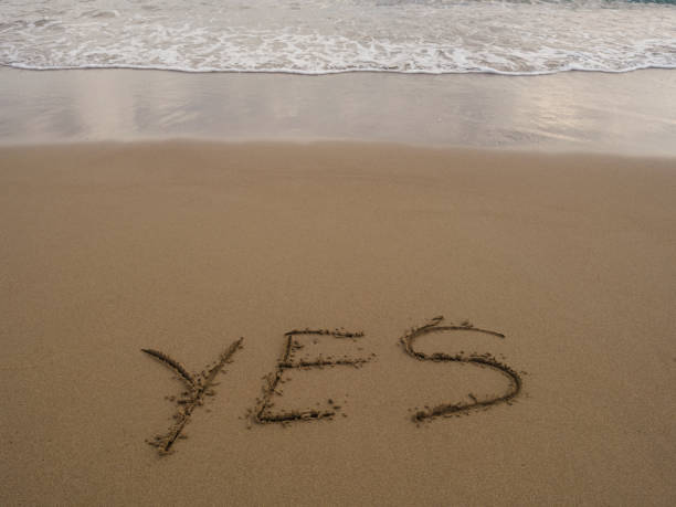 istock Yes - written in sand on sea beach texture 1447192179