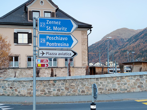 Samedan, Switzerland - October 2022: Direction indicators to the places Zernez, Saint Moritz, Pochiavo, Pontresina and the Engadin airport.