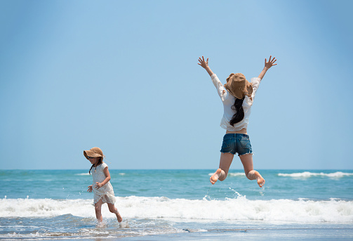 Mother and daughter having fun on the beach