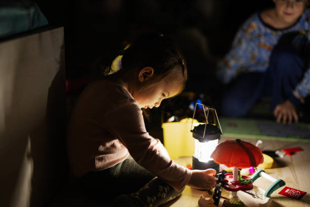istock Kids playing at home during a blackout using led lantern. 1447193640