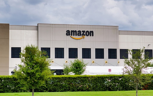 Houston, Texas USA 04-04-2021: Amazon warehouse facility storefront exterior in Houston, TX. American multinational technology company founded by Jeff Bezos in 1994.