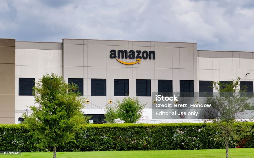 Amazon warehouse facility storefront exterior in Houston, TX. Houston, Texas USA 04-04-2021: Amazon warehouse facility storefront exterior in Houston, TX. American multinational technology company founded by Jeff Bezos in 1994. Amazon Prime Stock Photo