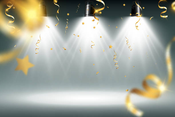 istock Golden confetti falls on a beautiful background. Falling streamers on stage. 1447199387