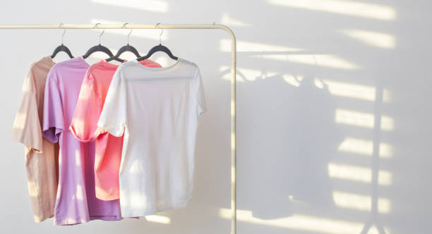 istock women's t-shirts on  hanger on  white background 1447200673