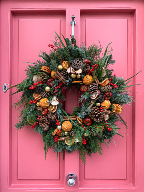 istock Christmas wreath on a pink door 1447200678