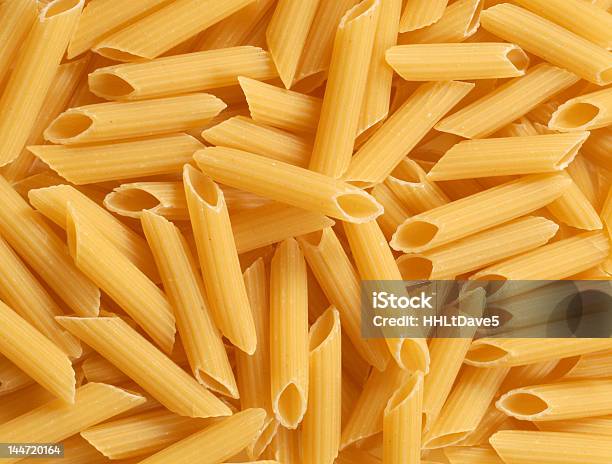 Background Of Fresh Uncooked Penne Pasta Stock Photo - Download Image Now - Mostaccioli, Backgrounds, Dinner