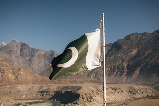 A Pakistan flag on the background of the Himalayas mountains